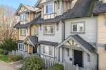 Discover the charm of this stunning townhome, featuring a beautifully designed exterior with a mix of siding and a welcoming front porch.