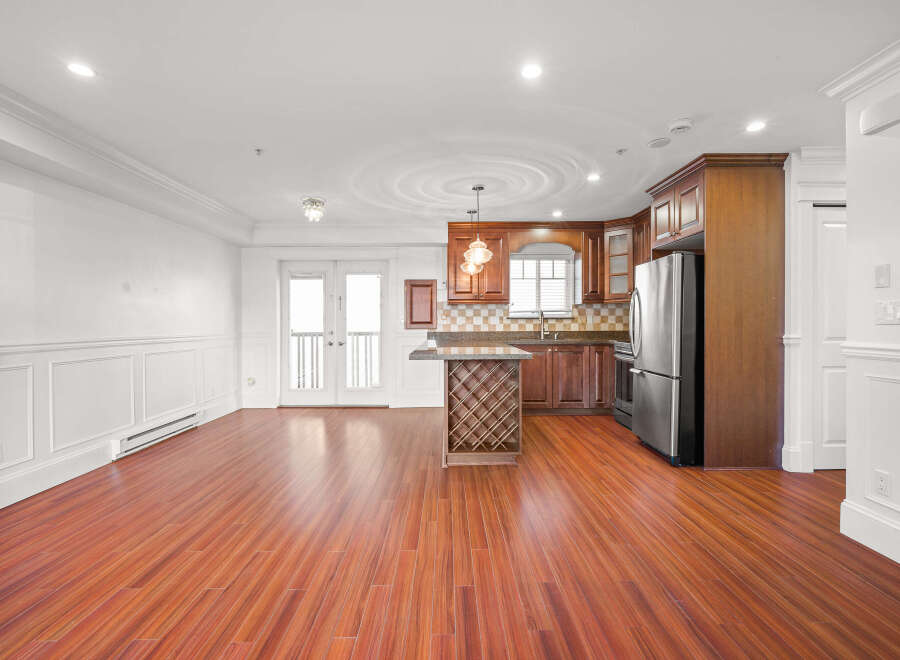 This stunning property boasts a spacious, open-concept living area with beautiful hardwood floors.