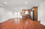 This stunning property boasts a spacious, open-concept living area with beautiful hardwood floors.