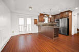 This stunning kitchen boasts a modern design with sleek stainless steel appliances and rich, dark wood cabinetry.