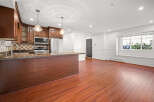 This stunning kitchen boasts rich wood cabinetry, stainless steel appliances, and a sleek granite countertop.