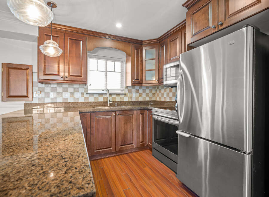 This stunning kitchen boasts rich wood cabinetry, offering ample storage and a warm, inviting atmosphere.
