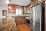 This stunning kitchen boasts rich wood cabinetry, offering ample storage and a warm, inviting atmosphere.