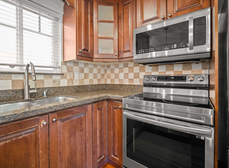 This stunning kitchen boasts beautiful wooden cabinetry and modern stainless steel appliances.