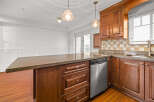 This stunning kitchen boasts rich, wooden cabinetry and a spacious granite countertop, perfect for meal preparation and entertaining.
