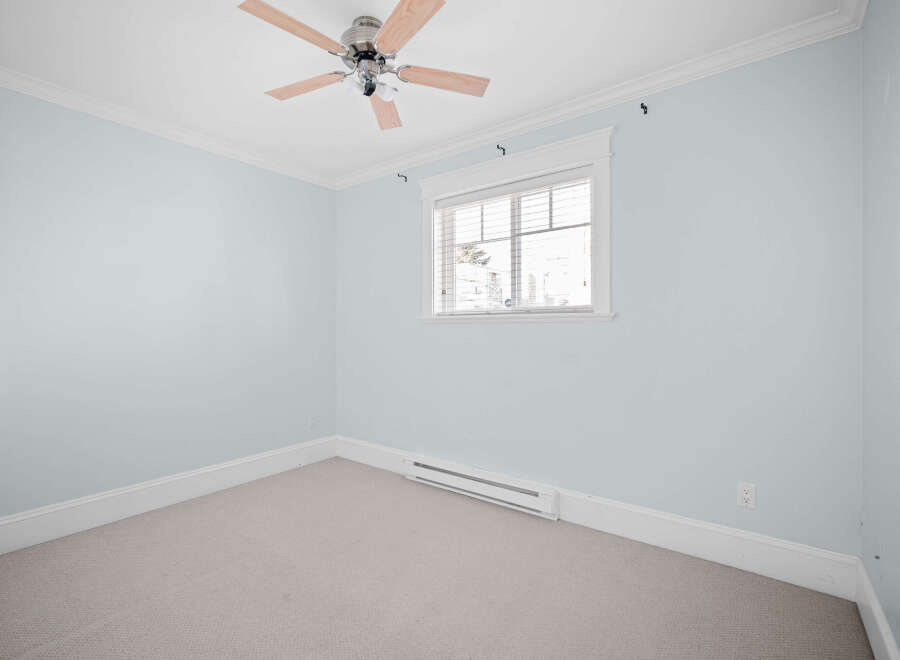 This inviting room boasts a fresh, airy ambiance, perfect for relaxation.