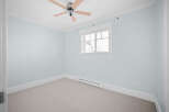 This inviting room boasts a fresh, airy ambiance, perfect for relaxation.
