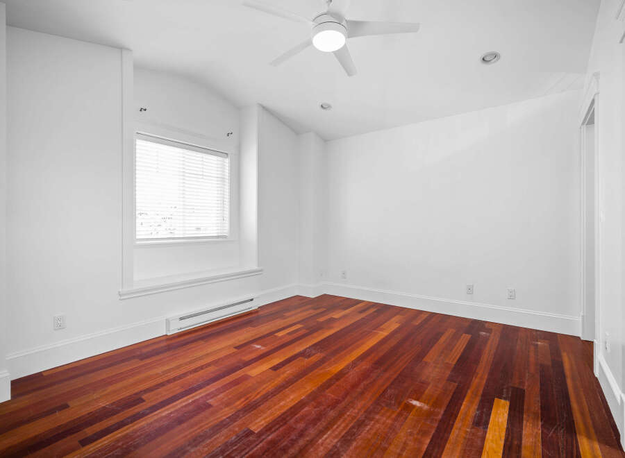 This stunning property boasts a bright and airy interior with pristine white walls and elegant hardwood floors.