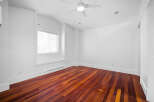 This stunning property boasts a bright and airy interior with pristine white walls and elegant hardwood floors.