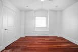 This stunning room boasts a bright and airy atmosphere with its pristine white walls and ample natural light.