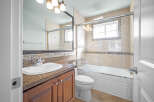 This beautiful bathroom features a modern design with a sleek vanity and a spacious bathtub.