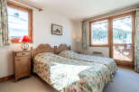This charming bedroom offers a cozy retreat with its two twin beds and floral bedding.