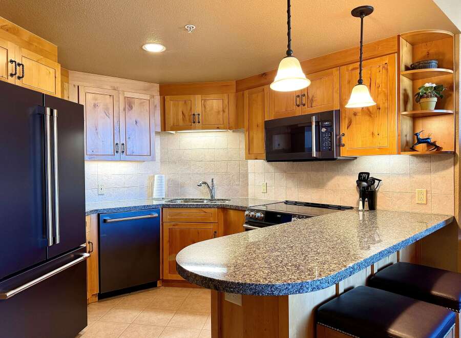 This stunning kitchen boasts custom cabinetry, granite countertops, and modern appliances.