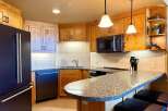 This stunning kitchen boasts custom cabinetry, granite countertops, and modern appliances.