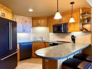 This stunning kitchen boasts custom cabinetry, granite countertops, and modern appliances.