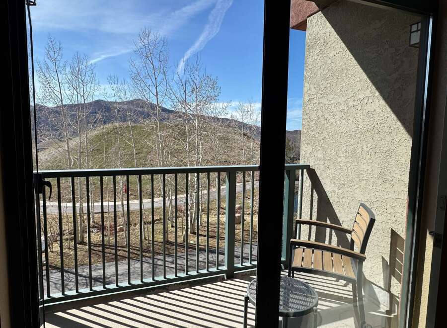 Enjoy breathtaking mountain views from this charming balcony.