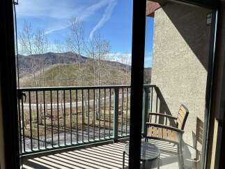 Enjoy breathtaking mountain views from this charming balcony.