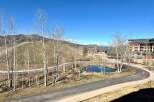 Enjoy the serene beauty of this property, featuring a picturesque pond and winding pathways.