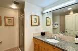 Step into this beautifully designed bathroom, featuring a granite countertop and wooden cabinetry that exudes timeless elegance.