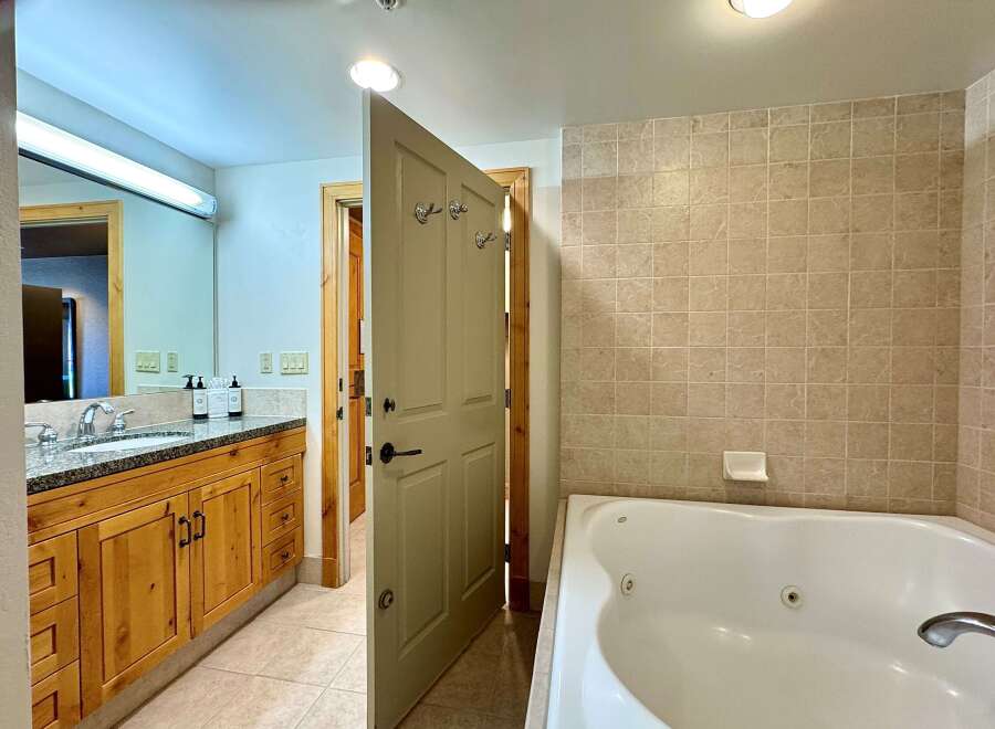 Step into a luxurious bathroom featuring a spacious jacuzzi tub, perfect for relaxation.