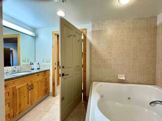 Step into a luxurious bathroom featuring a spacious jacuzzi tub, perfect for relaxation.