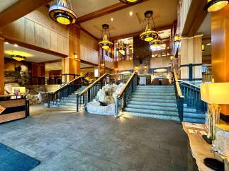 Step into luxury at this stunning property, featuring a grand entrance with a cascading waterfall and elegant staircases.
