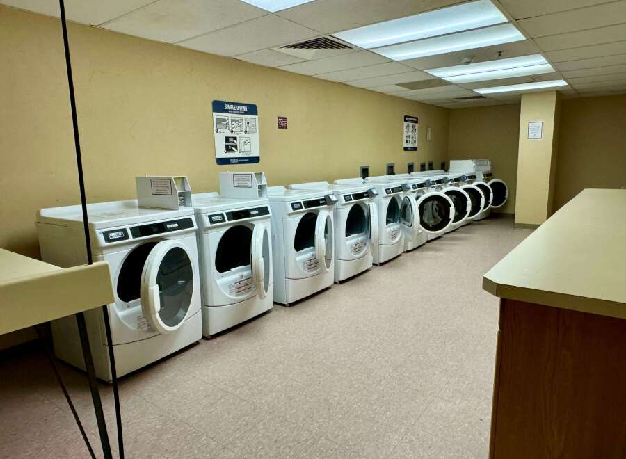 This laundry room features multiple Maytag dryers, perfect for handling large loads of laundry.