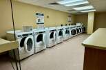 This laundry room features multiple Maytag dryers, perfect for handling large loads of laundry.