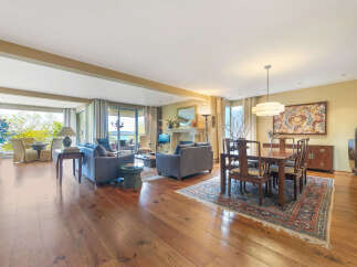Experience luxury living in this stunning property, featuring a spacious open floor plan with beautiful hardwood floors throughout.