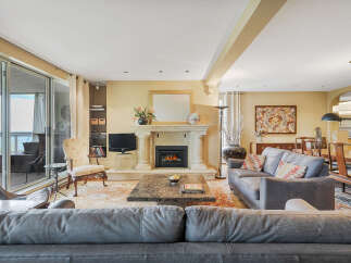 This stunning living room boasts a cozy fireplace, perfect for relaxing evenings.