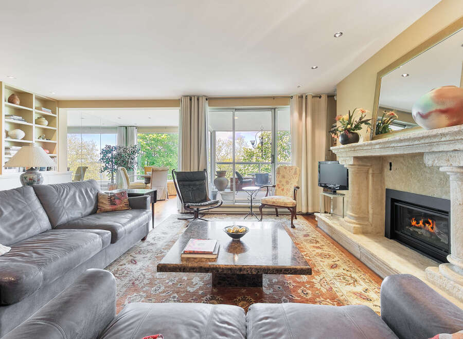 Step into luxury with this stunning living room, featuring a cozy fireplace and elegant design.