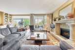 Step into luxury with this stunning living room, featuring a cozy fireplace and elegant design.