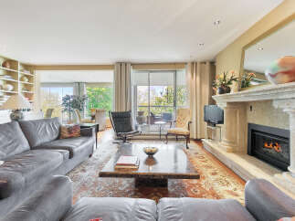 Step into luxury with this stunning living room, featuring a cozy fireplace and elegant design.