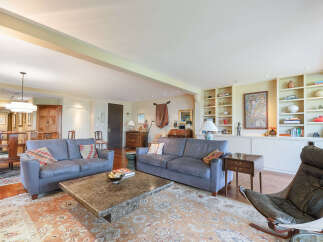 Step into luxury with this stunning living room, featuring two elegant sofas and a stylish marble coffee table.