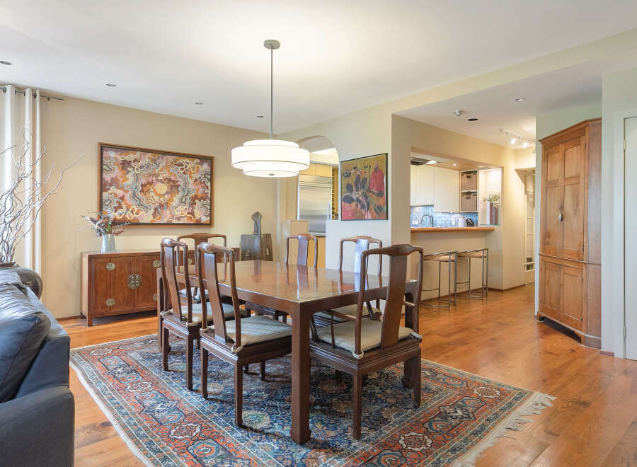 Step into this elegant dining room, featuring a beautiful wooden dining table and chairs, perfect for hosting gatherings.