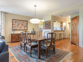 Step into this elegant dining room, featuring a beautiful wooden dining table and chairs, perfect for hosting gatherings.