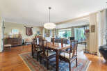 Step into luxury with this stunning dining room, featuring a beautiful wooden dining table and chairs.