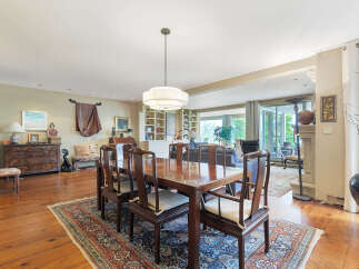 Step into luxury with this stunning dining room, featuring a beautiful wooden dining table and chairs.