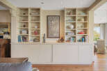 This stunning property boasts a custom-built shelving unit, perfect for displaying your favorite books and decor.
