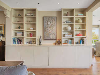 This stunning property boasts a custom-built shelving unit, perfect for displaying your favorite books and decor.