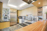 This stunning kitchen boasts modern design with high-end appliances and ample counter space.