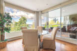Enjoy breathtaking views from this stunning property, featuring a bright and airy dining area with floor-to-ceiling windows.
