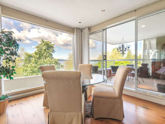 Enjoy breathtaking views from this stunning property, featuring a bright and airy dining area with floor-to-ceiling windows.