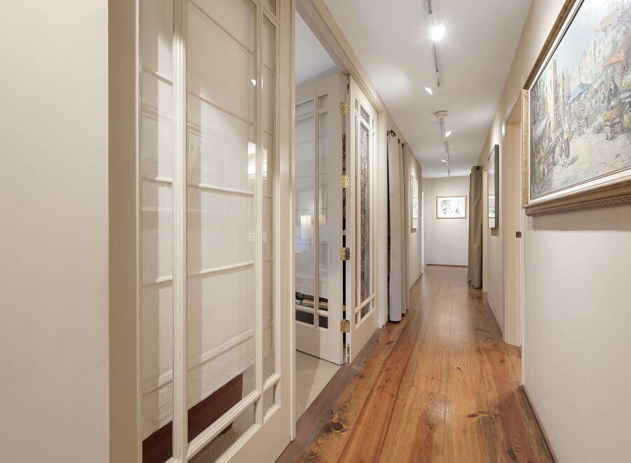 Step into this inviting hallway, showcasing beautiful hardwood floors that extend throughout the space.