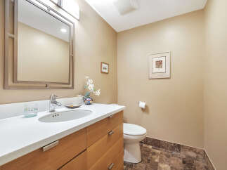 This stunning bathroom features a modern design with a sleek vanity and a stylish mirror.