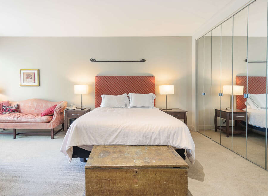Step into this inviting bedroom, featuring a cozy bed with a stylish headboard.