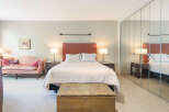 Step into this inviting bedroom, featuring a cozy bed with a stylish headboard.