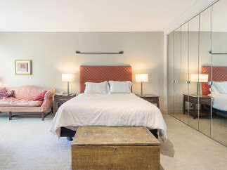 Step into this inviting bedroom, featuring a cozy bed with a stylish headboard.