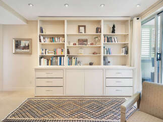This stunning property boasts a custom-built bookshelf, perfect for displaying your literary collection and decorative items.