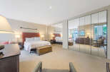 This stunning bedroom boasts a spacious layout with ample natural light, creating a serene and inviting atmosphere.